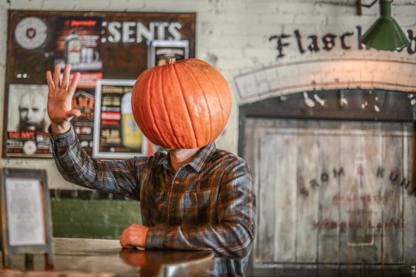 pumpkin-headed person at brewery