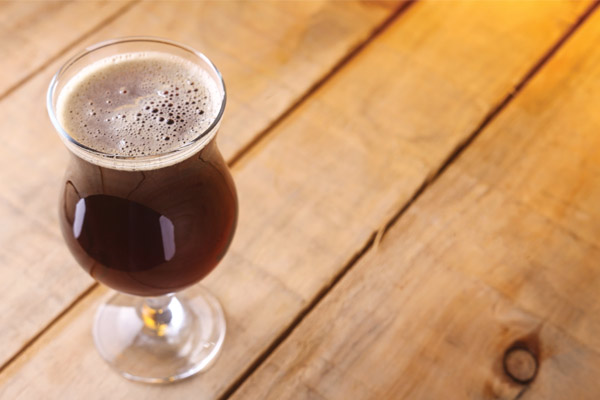 brown-colored beer in tulip glass