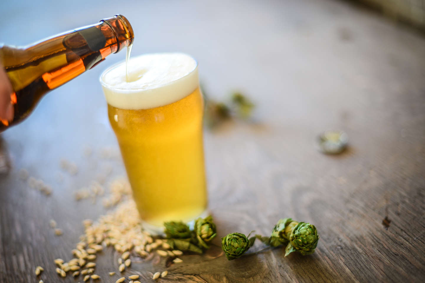 gold hazy beer being poured