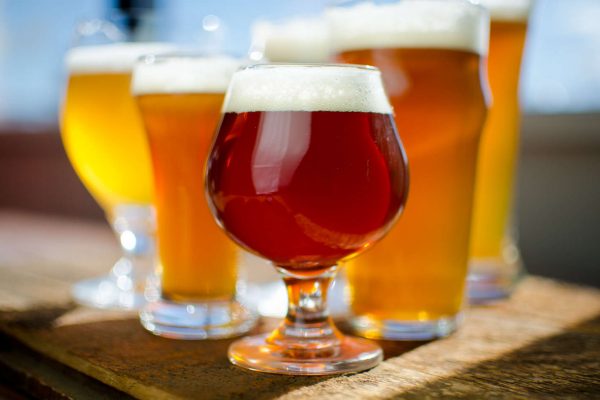 5 different-colored beers in glasses