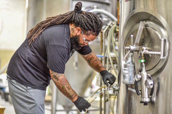 person working in a commercial brewery