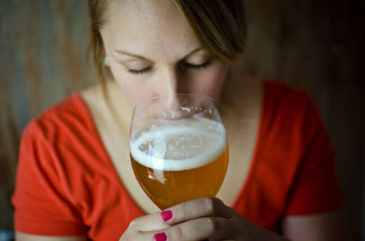 woman smelling a beer