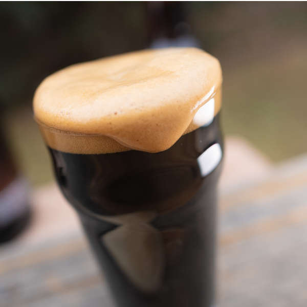 overflowing glass of stout