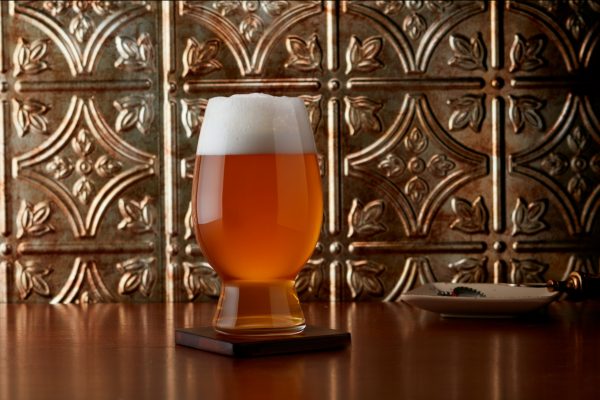 copper-colored beer in a unique-shaped glass
