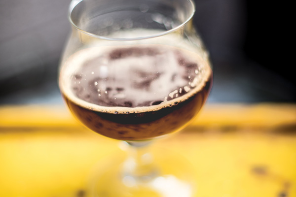 brown beer in a snifter glass